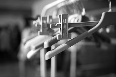 Close-up of coathangers hanging on rack at backstage
