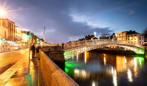 View of bridge over river against cloudy sky