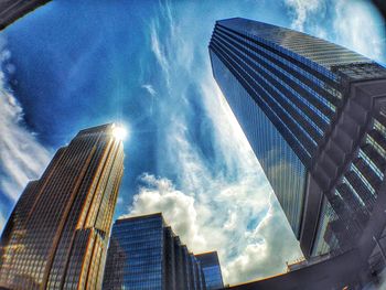 Low angle view of modern building against cloudy sky