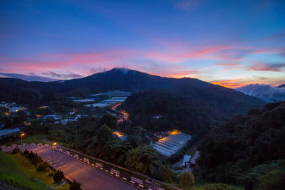 High angle view of road amidst mountains against sky during sunset