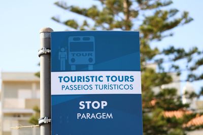 Low angle view of information sign against trees