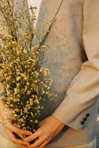 Close-up of hand holding flowering plant