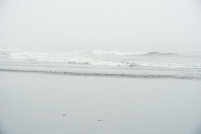 Scenic view of sea against sky during winter