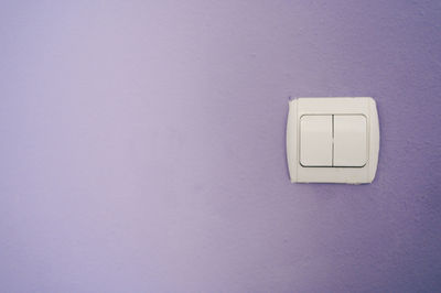 Close-up of electric lamp on wall