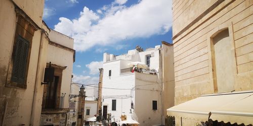 Low angle view of buildings against sky in city