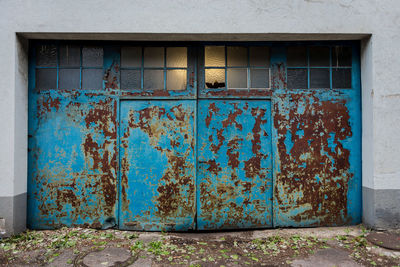 Rusty metallic door of building