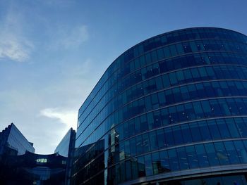 Low angle view of modern building against blue sky
