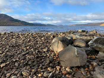 Rocks on beach against sky