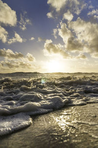 Scenic view of beach against sky during sunset