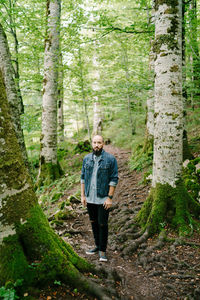 Portrait of man standing in forest
