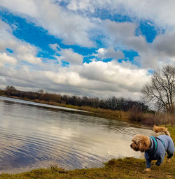 View of dog on lake against sky