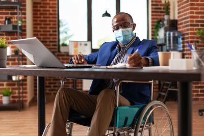 Businessman wearing mask working at office