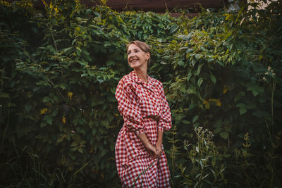 Portrait of a smiling young woman standing outdoors