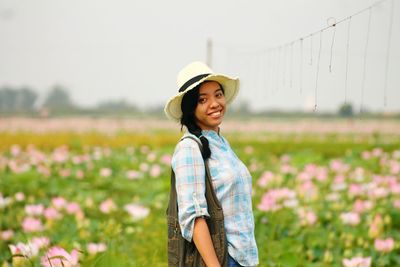 Close-up of a smiling young woman in field