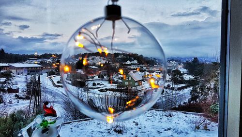 Illuminated city against sky during winter