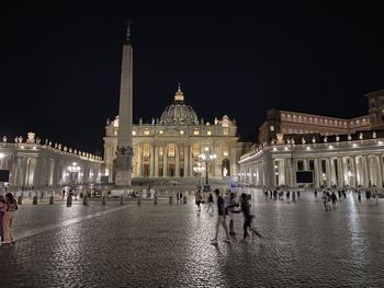 Group of people in front of building at night