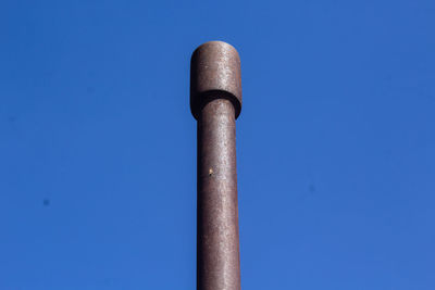 Low angle view of pole against clear blue sky