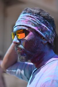 Man in sunglasses covered with powder paint