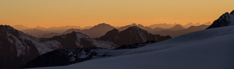 Scenic view of mountains against clear sky during sunset