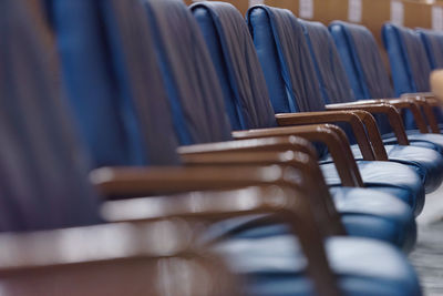 Empty chairs arranged in row