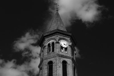 Low angle view of tower against cloudy sky