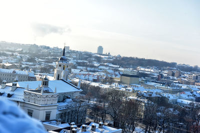 High angle view of snow covered houses against sky