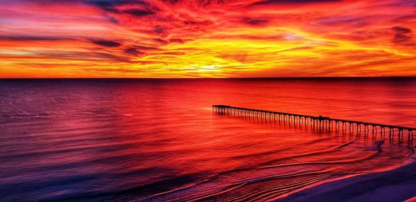 Scenic view of sea against romantic sky at sunset