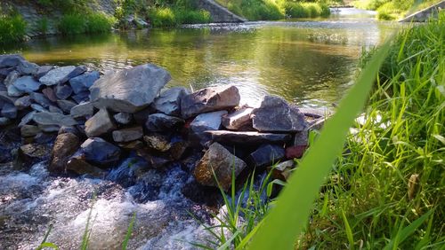 Stream flowing through rocks in lake