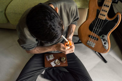 Rear view of man playing guitar