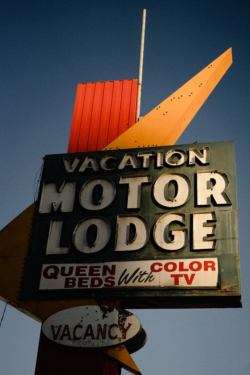 communication, text, western script, sky, low angle view, sign, number, no people, clear sky, information, day, capital letter, nature, architecture, information sign, outdoors, blue, built structure, close-up, building exterior