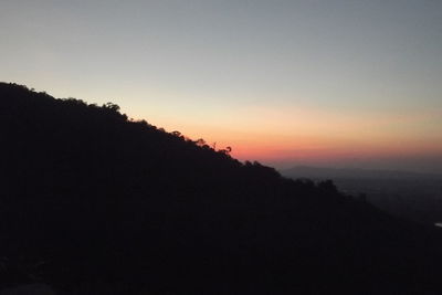 Silhouette trees against sky during sunset