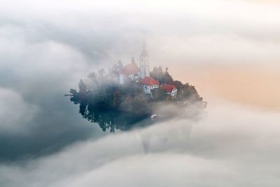 High angle view of boats in water against cloudy sky