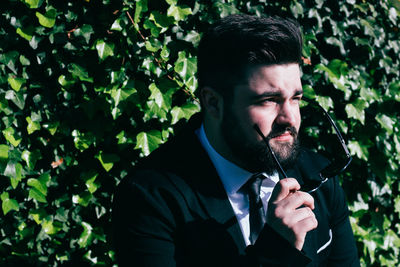 Portrait of young man with plants