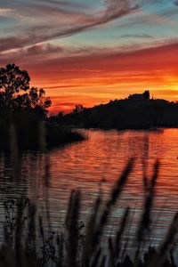 Scenic view of lake against romantic sky at sunset