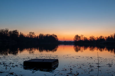 Scenic view of lake against sky during sunset