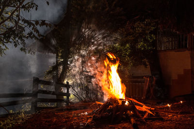 Bonfire against sky at night during camping