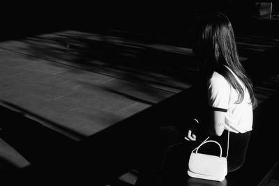 Side view of woman standing in train