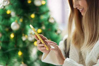 Close-up of woman holding christmas tree