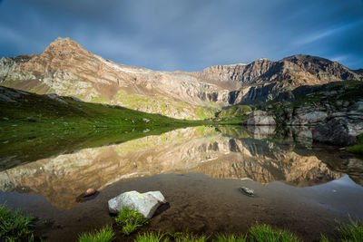 Scenic view of lake and mountains against sky