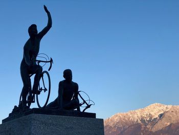 Low angle view of statue against clear blue sky
