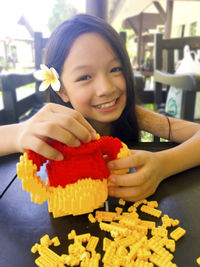 Close-up portrait of smiling girl holding ice cream