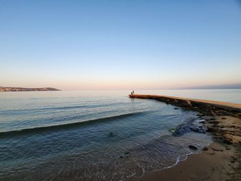Scenic view of sea against clear sky during sunset