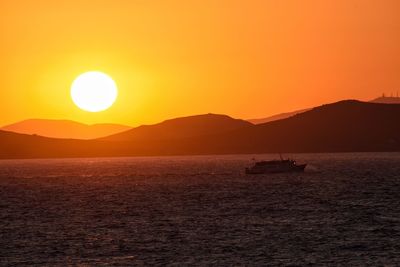 Scenic view of sea against orange sky