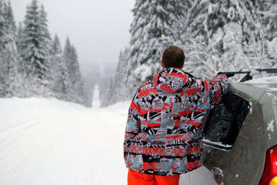 Rear view of man in snow during winter