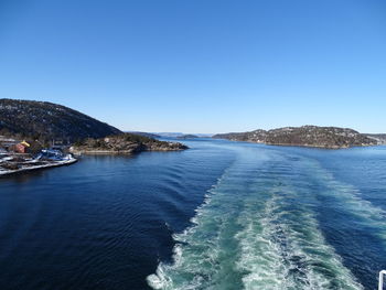 Scenic view of sea against clear blue sky