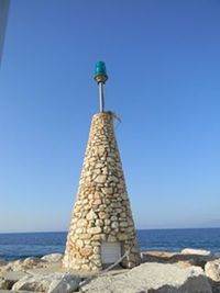 View of lighthouse against clear blue sky