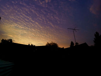 Silhouette built structures at sunset