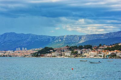 Scenic view of sea and mountains against sky
