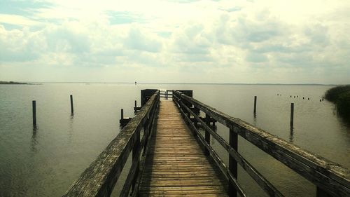 Pier over sea against sky