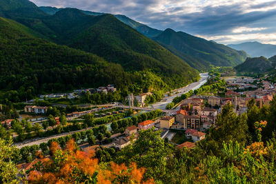 High angle view of townscape by mountain against sky